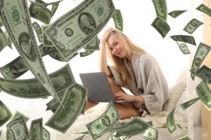 Woman With Laptop Computer and Money